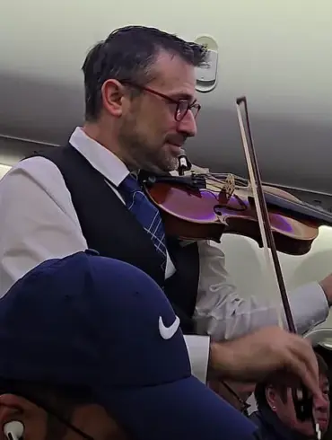 United Airlines Crew Member's Violin Serenade: A Surprising Interruption or Welcoming Surprise?